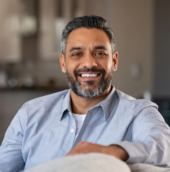 mature-man-smiles-blue-shirt