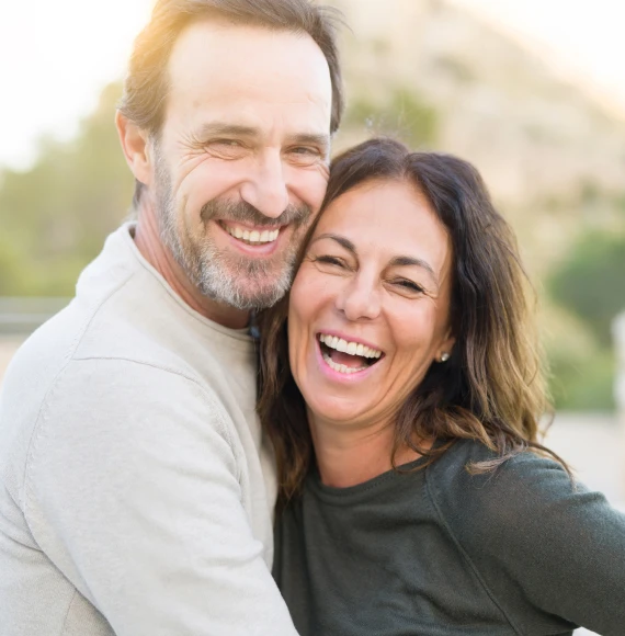middle-aged-couple-laugh-and-hold-each-other-wellness-page