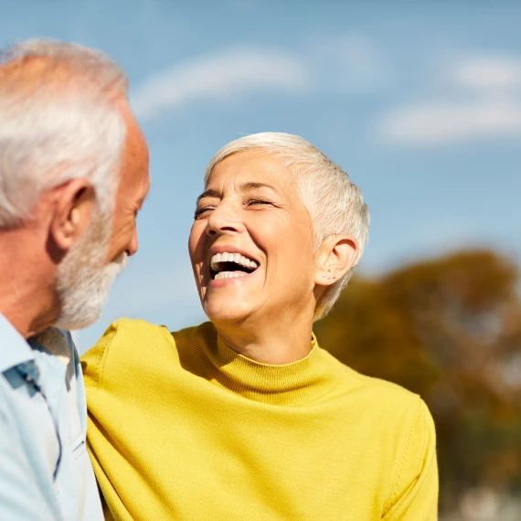 older-couple-laugh-and-look-at-each-other