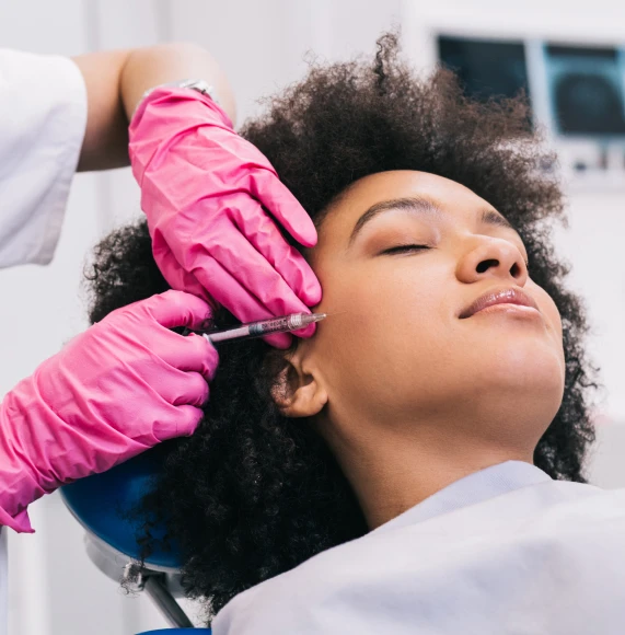 pink-gloves-woman-with-afro-facial-injection-page