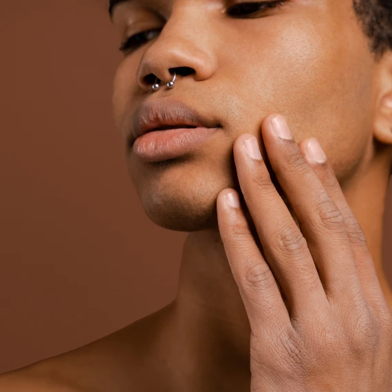 young-man-with-septum-piercing-brown-bg